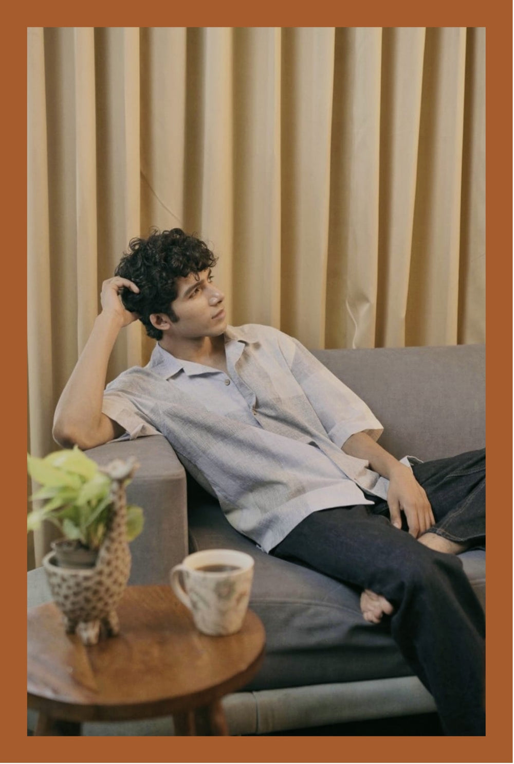 Relaxing on a sofa with coffee in a checked cotton shirt, Modus & Mood concept