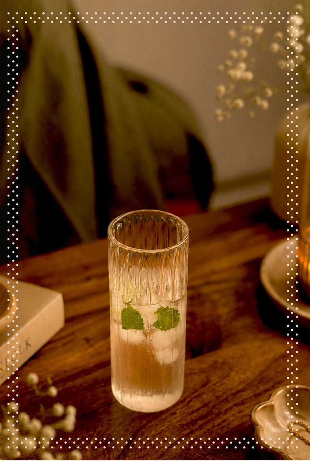 Ribbed glass tumbler on a wooden table in evening light, Modus & Mood concept