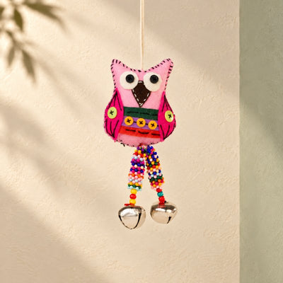Hanging decorations: a pink embroidered wool-felt owl with bells