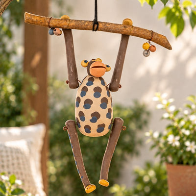 Nerikomi: a spotted clay monkey hanging from a branch